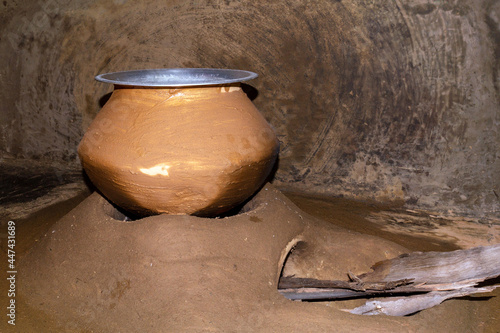 Cooking pot on a wood fired clay oven at rural village In India