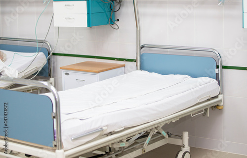 Part of a hospital ward or intensive care unit with a bed.