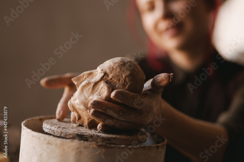 Young woman sculptor artist creating a bust sculpture