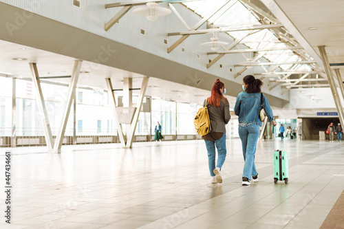 Young multiracial two women walking at train station