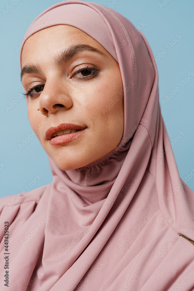 Young muslim woman in hijab posing and looking at camera Young muslim woman in hijab posing and looking at camera