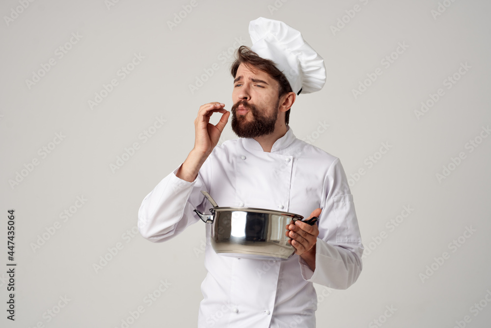 professional chef with a saucepan in his hands trying food cooking work professional chef with a saucepan in his hands trying food cooking work