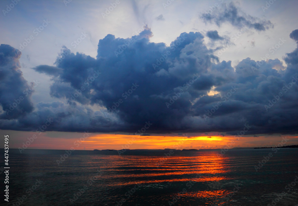 Beautiful scenic landscape with dramatic cloudy sky at sunset and a sun glade on a ripple sea water in Sihanouk ville, Gulf of Thailand, Pacific Ocean, Cambodia, South East Asia