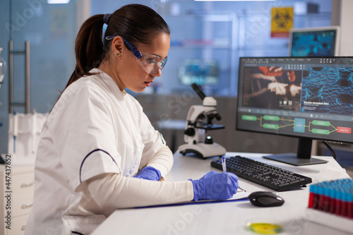 Microbiology specialist testing dna sample on microscope in science laboratory. Chemical analysis woman working with medical equipment for advanced development healthcare treatment