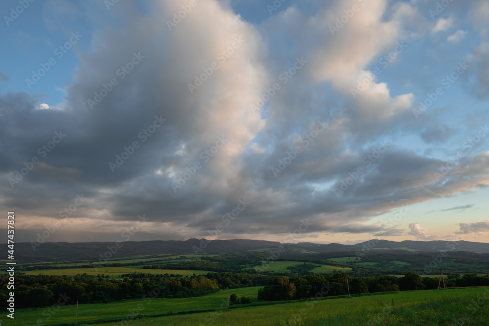 beautiful clouds at sunset green meadow