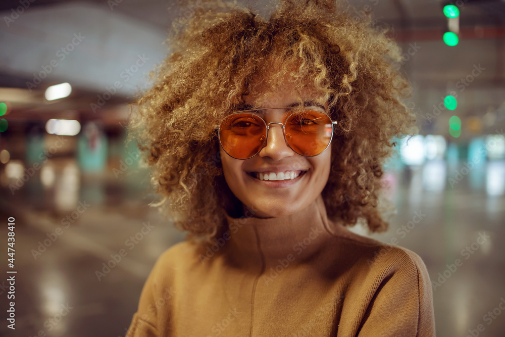 Portrait of smiling mixed race hip hop girl with sunglasses looking at camera. Portrait of smiling mixed race hip hop girl with sunglasses looking at camera.
