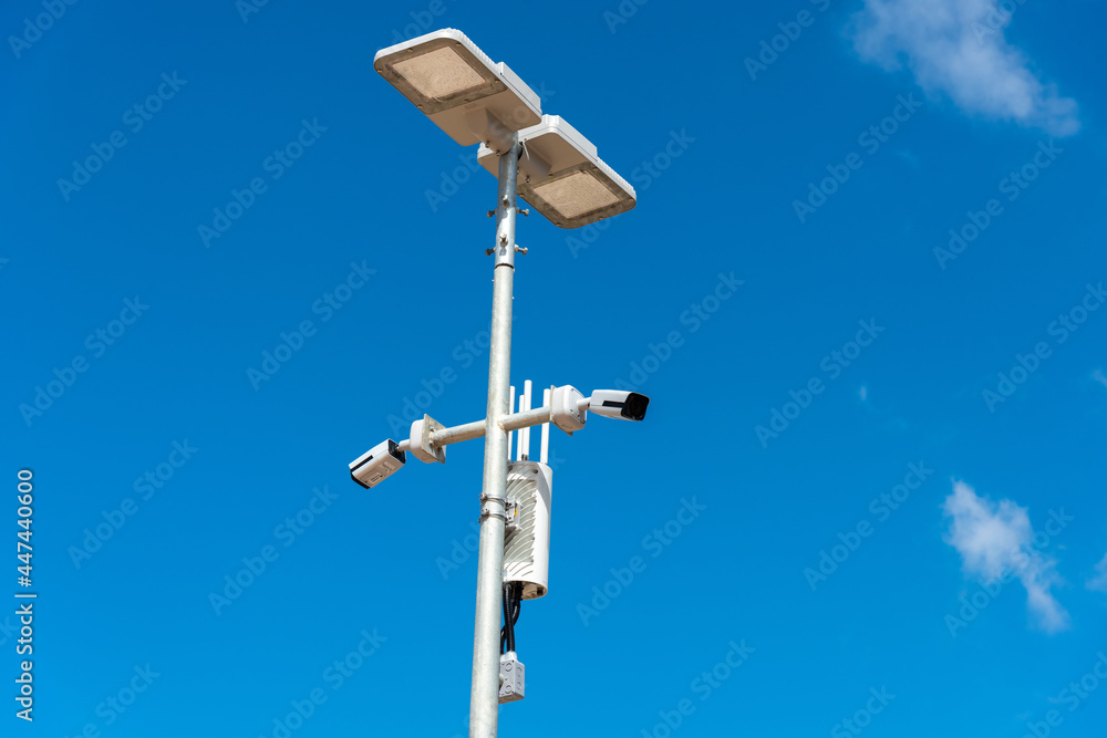 CCTV camera with blue sky background. Close-up of outdoor surveillance cameras on a street pole, Ensuring security on the street.. CCTV camera with blue sky background. Close-up of outdoor surveillance cameras on a street pole, Ensuring security on the street..