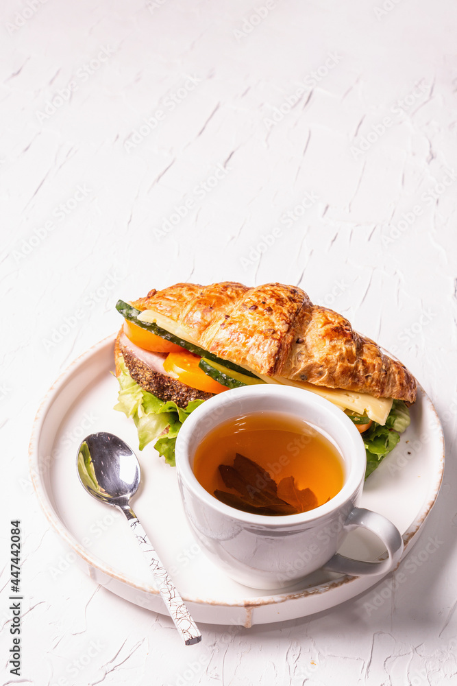 Healthy breakfast concept. Morning good mood with tea and croissant Healthy breakfast concept. Morning good mood with tea and croissant