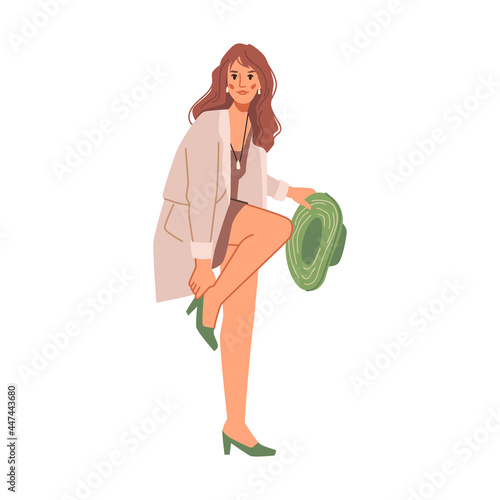 Woman in high heel green shoes and broad hat in hands isolated flat cartoon character. Vector pretty girl trying on perfect pair, shopper choose footwear. Sexy trendy lady in coat, brunette girl