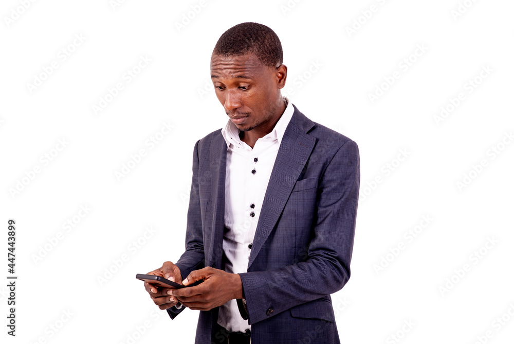 young serious businessman working on a mobile phone. young serious businessman working on a mobile phone.