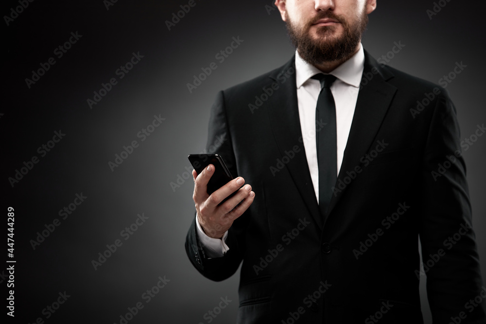 Close up of man in suit using smart phone