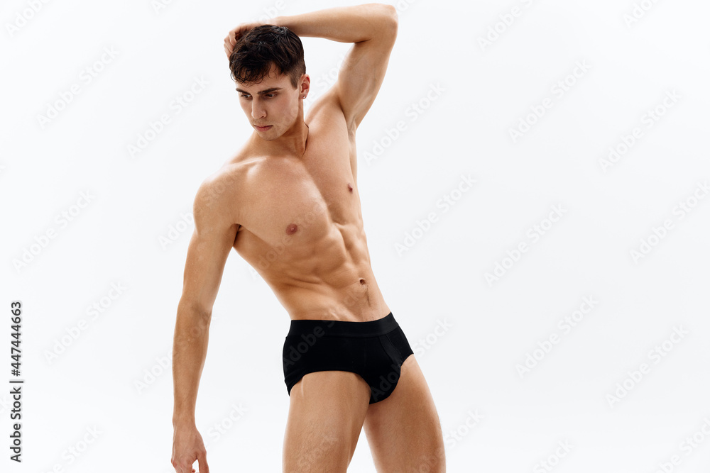 handsome man with pumped up body black panties isolated background handsome man with pumped up body black panties isolated background