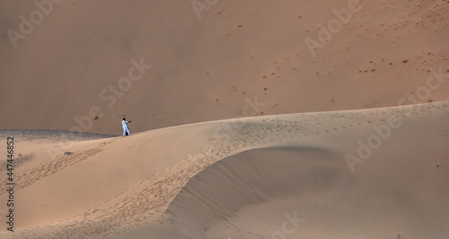 A Saudi couple take a selfie in the huge sand dunes in Badr, Medina, Saudi Arabia photo