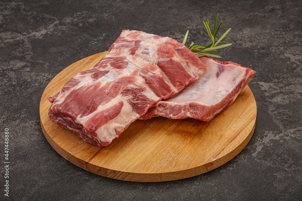 Raw pork ribs served rosemary