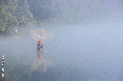 casting fishing net closeup on mist river © chungking