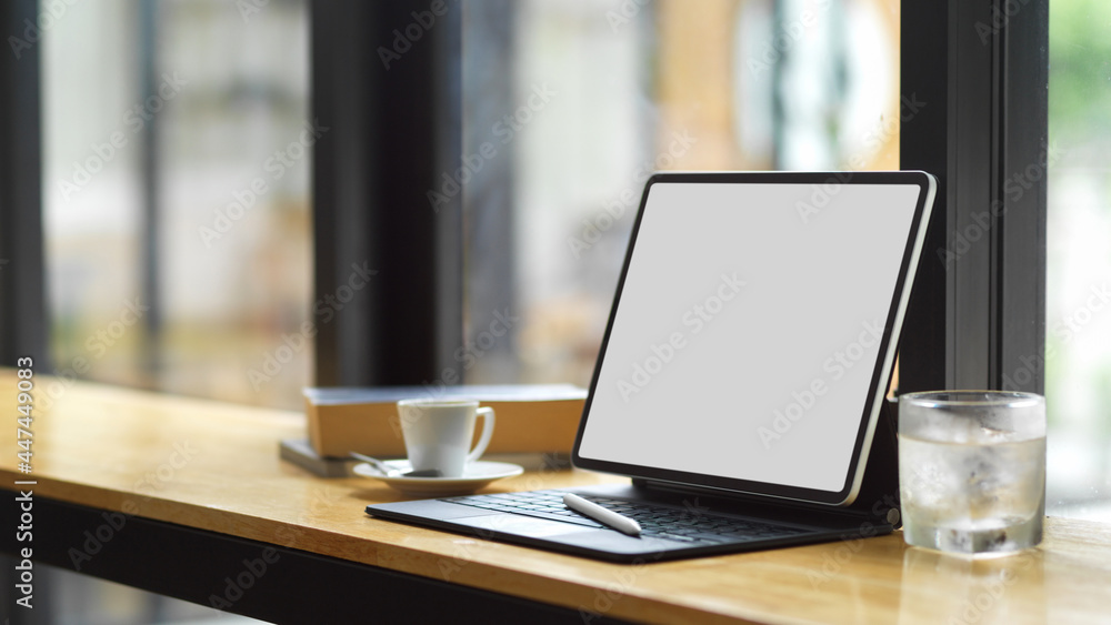 Blank screen tablet with keyboard and copy space on wooden table Blank screen tablet with keyboard and copy space on wooden table