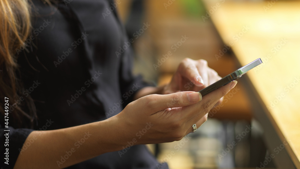 Businesswoman checking business email via smartphone