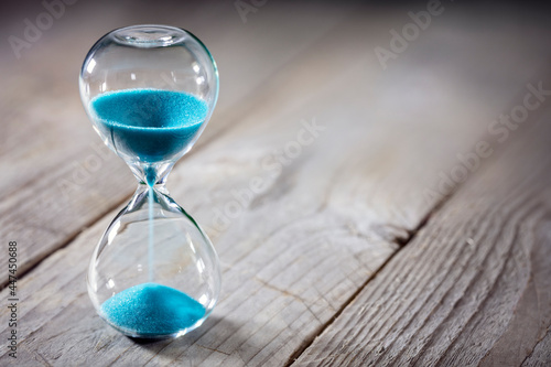Hourglass background concept for deadline, urgency and countdown photo