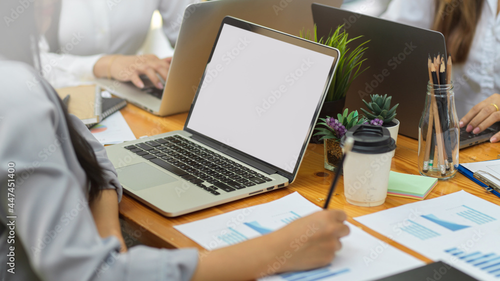 Business team working at office with personal laptop in blank screen Business team working at office with personal laptop in blank screen