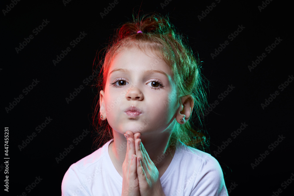 girl making a quiet gesture on black background girl making a quiet gesture on black background