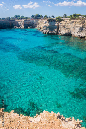 Torre Sant Andrea, Salento sea coast, Apulia, Italy. Faraglioni Melendugno. Beautiful rocky Seascape with cliffs in Puglia. Blue turquoise saturated clear water. Bright Summer day.