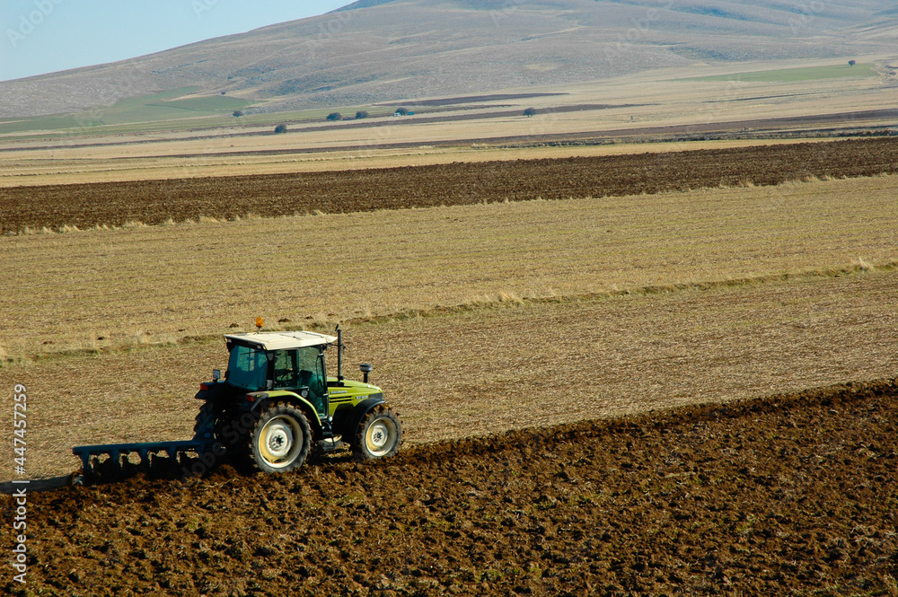 Obraz premium aerial photo of tractor plowing the field