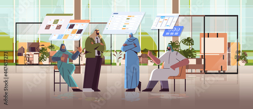 arab businesspeople team analyzing statistic data on virtual boards successful teamwork concept
