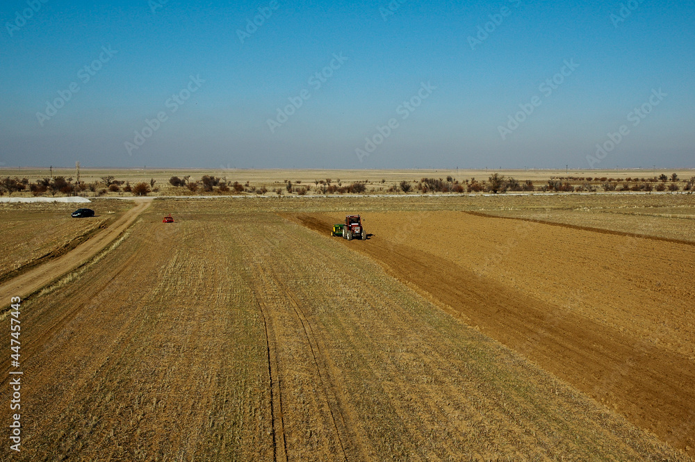 aerial photo of tractor plowing the field aerial photo of tractor plowing the field