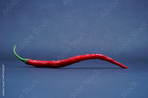 Red chili pepper isolated on a black background, focus selected