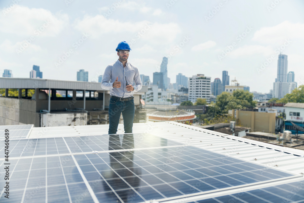 Green ecological power energy generation. Man show thumb up and standing near solar panels.