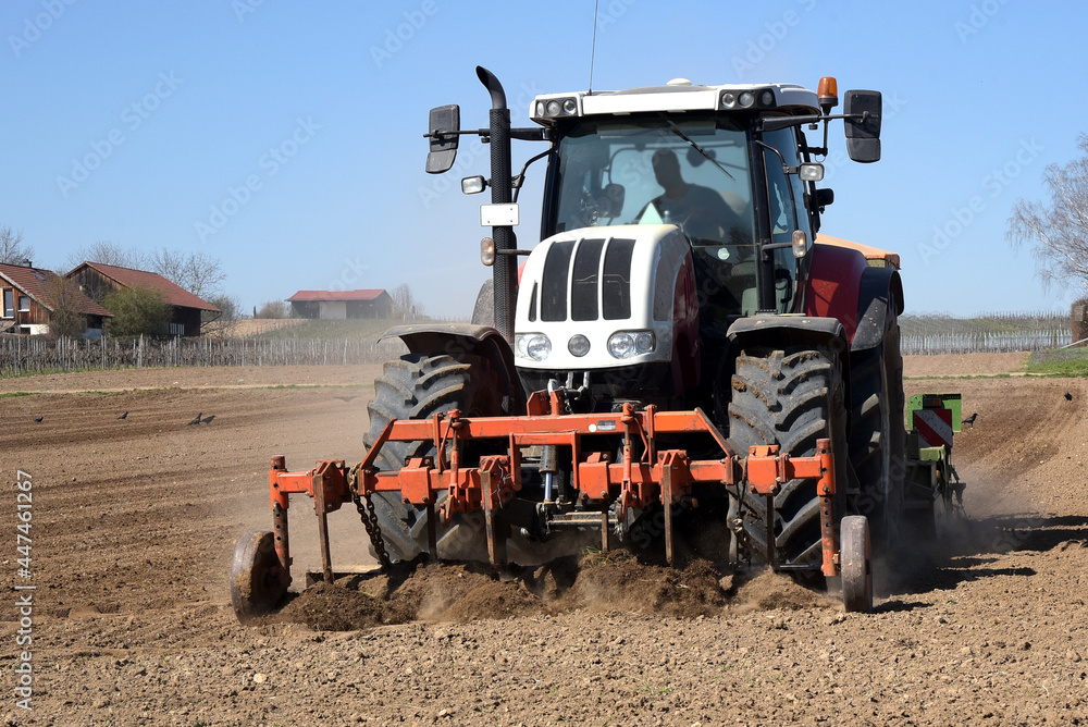 11.30 Tuesday 30 March 2021. Hintergasse, Saulheim, Rhineland-Palatinate, Germany. Tractor Ploughing and sowing seeds onto an agricultural field on a sunny day at the start of the spring season. 11.30 Tuesday 30 March 2021. Hintergasse, Saulheim, Rhineland-Palatinate, Germany. Tractor Ploughing and sowing seeds onto an agricultural field on a sunny day at the start of the spring season.
