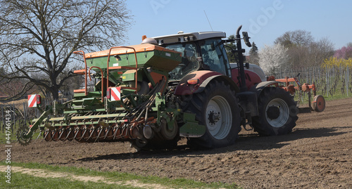 11.30 Tuesday 30 March 2021. Hintergasse, Saulheim, Rhineland-Palatinate, Germany. Tractor Ploughing and sowing seeds onto an agricultural field on a sunny day at the start of the spring season. 