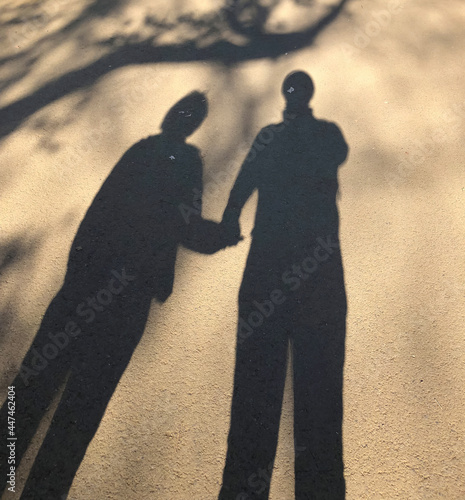 Shadow of the couple tying a hand