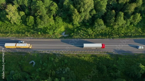 Several trucks and a semi-truck on a regional road. The concept of delivery of perishable goods, food products containers. High quality. 4k footage.