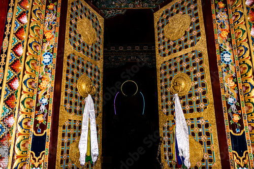 Buddhist monastery entry gate with art work at day from low angle