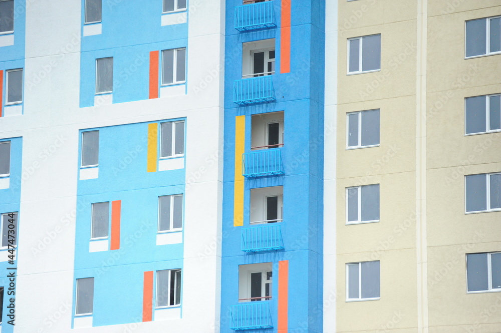 Windows of new residential buildings with different colors on the facade.