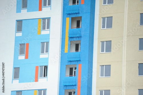 Windows of new residential buildings with different colors on the facade.