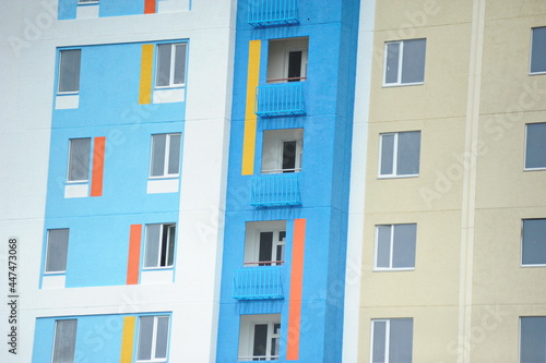 Windows of new residential buildings with different colors on the facade.