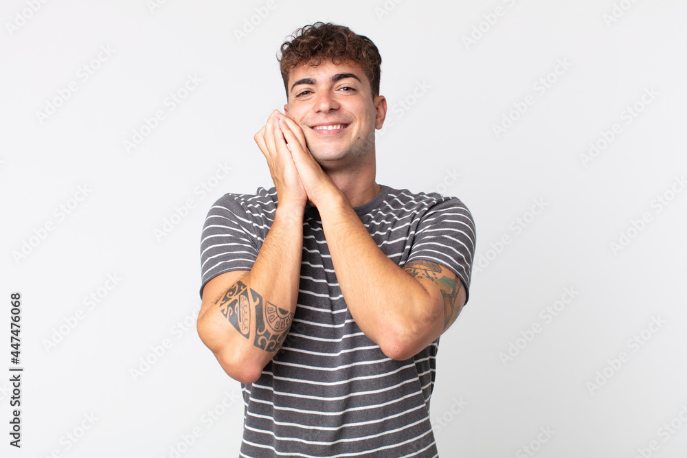 young handsome man feeling in love and looking cute, adorable and happy,  smiling romantically with hands next to face Stock-Foto | Adobe Stock