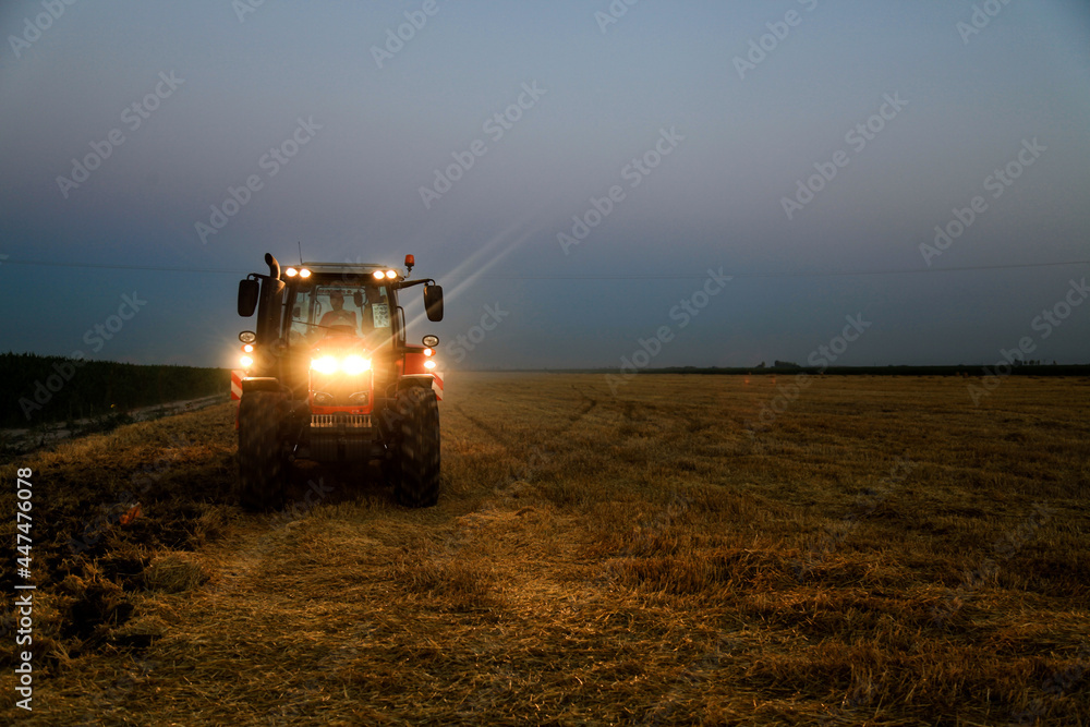 Fototapeta premium combine harvester in the field at evening