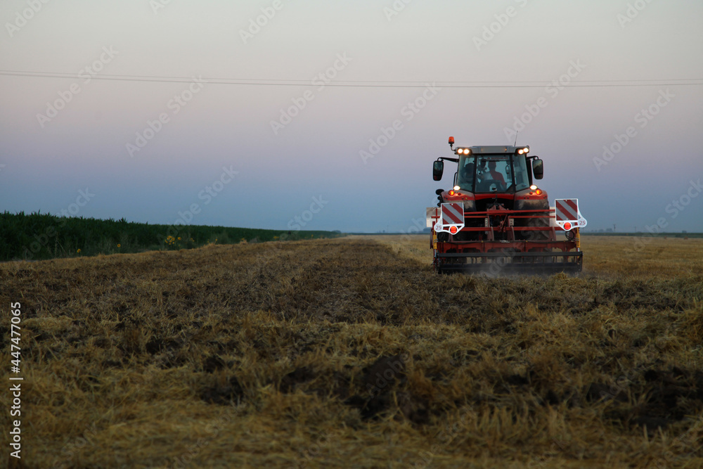combine harvester in the field at evening
