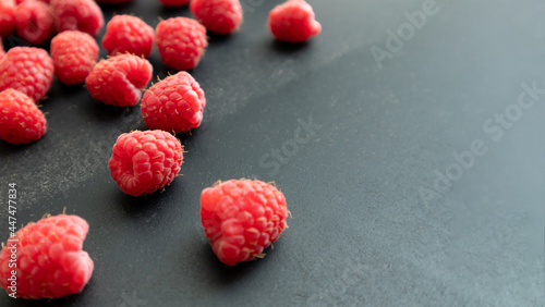 Fresh and sweet raspberry in a dark background. Selective focus.