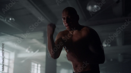 Male boxer practicing hand speed drill in modern gym. Man fighting with shadow © stockbusters