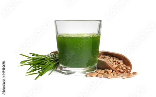 Glass of fresh wheat grass juice, seeds and sprouts on white background