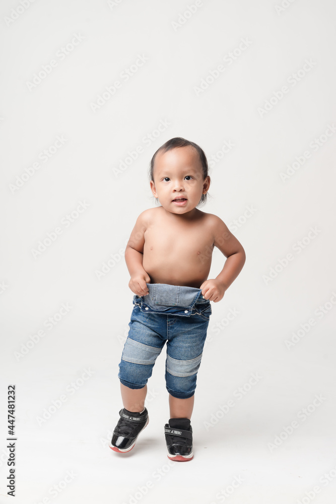 Asian boy wearing denim overalls is walking. Asian boy wearing denim overalls is walking.