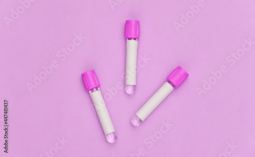 Medical test tubes on pink background. Top view