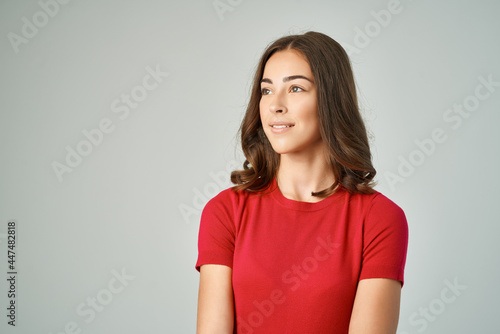 pretty brunette in red t-shirt cropped view smile isolated background