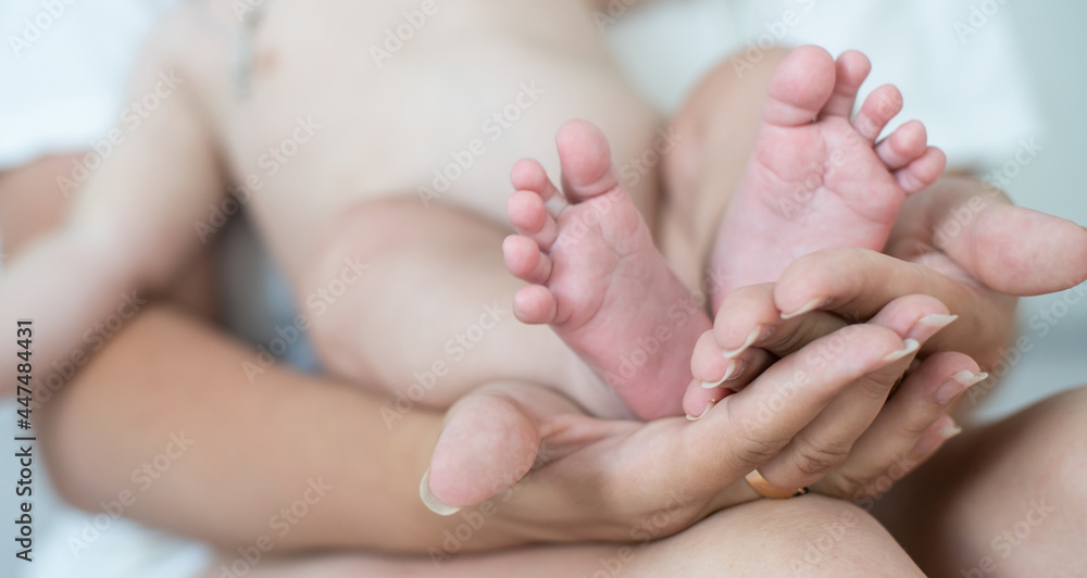 Happy smiling mother and baby lying on bed at home Happy smiling mother and baby lying on bed at home