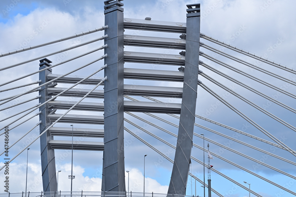 The pylons of the cable-stayed bridge connected to the road by means of metal rods The pylons of the cable-stayed bridge connected to the road by means of metal rods