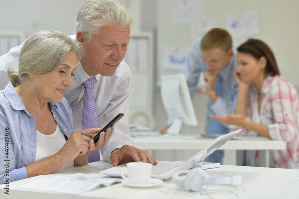senior couple working in office senior couple working in office